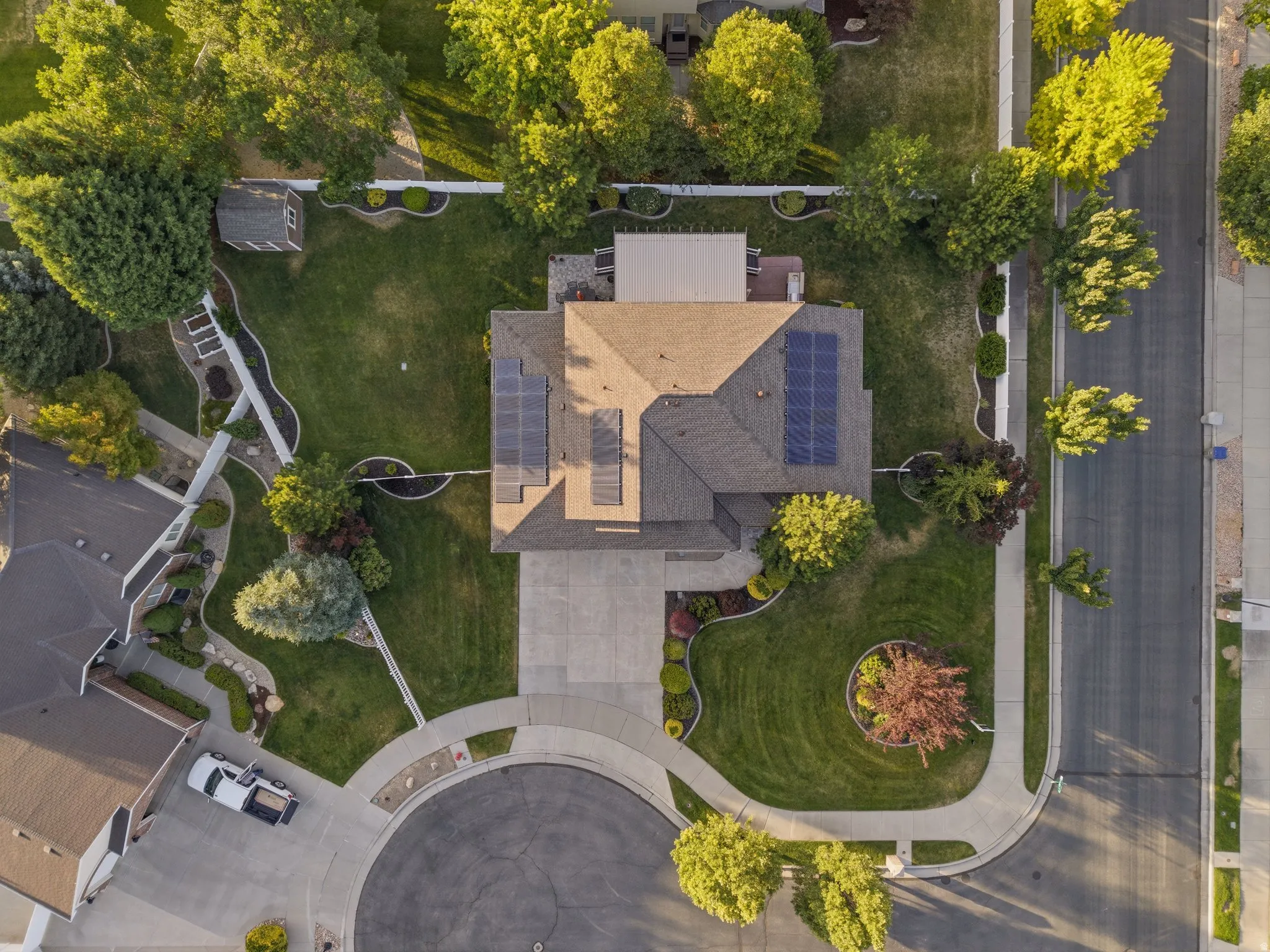 Aerial perspective showcasing a residential property with a shingled roof and solar panels