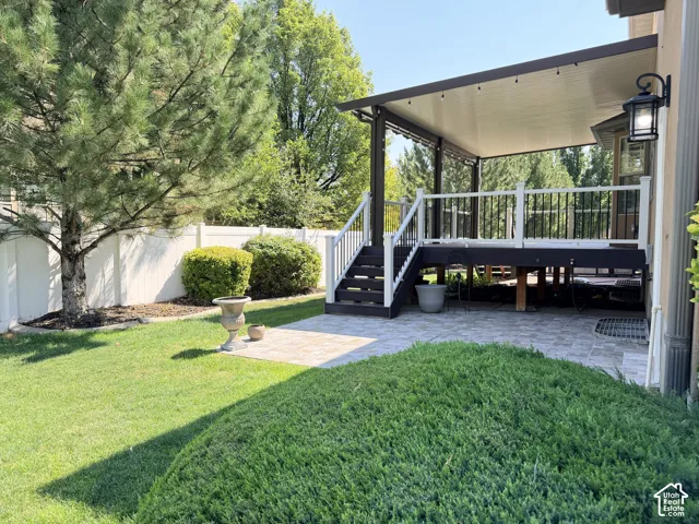 Covered outdoor deck with white railing, black balusters, and integrated lighting