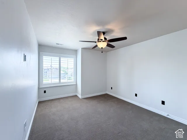 Bedroom 3 Plush carpet flooring, a ceiling fan with integrated lighting, window with white plantation shutters, and light-toned wall finishes
