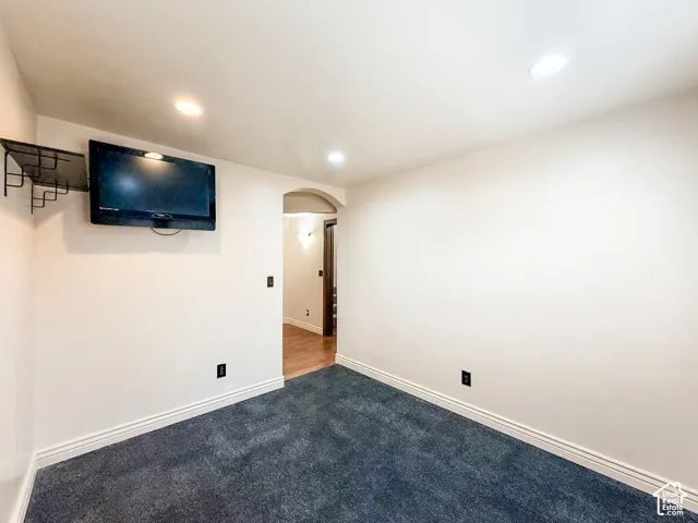 Recessed ceiling lighting, wall-mounted television bracket, and archway