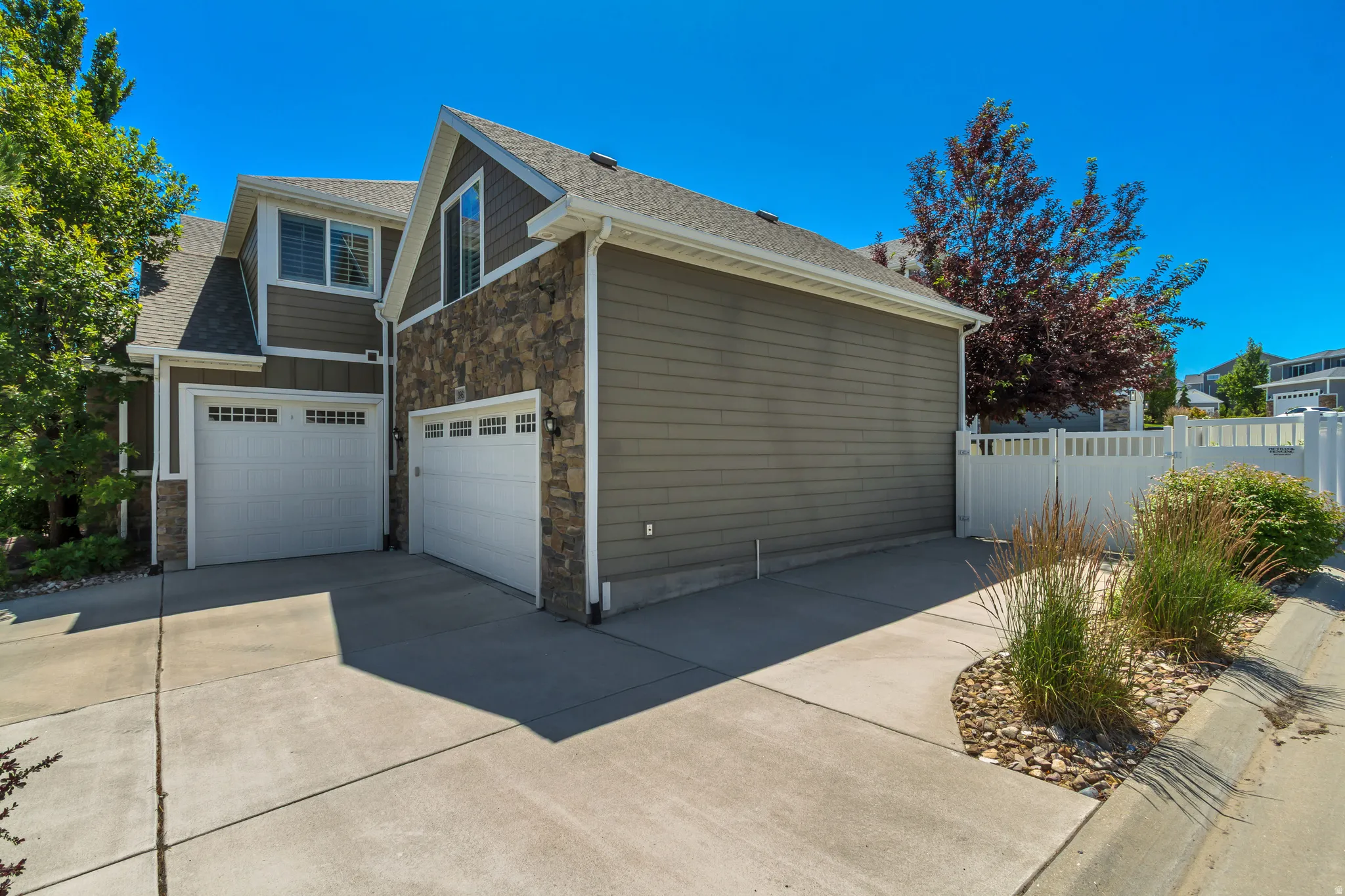 Multi-car concrete driveway with an attached two-car garage
