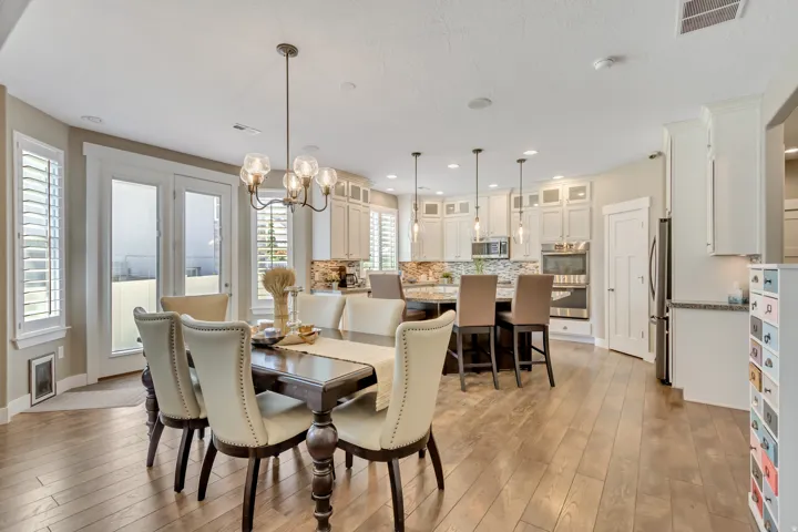Open-concept living space with wood-finish flooring extending into the kitchen