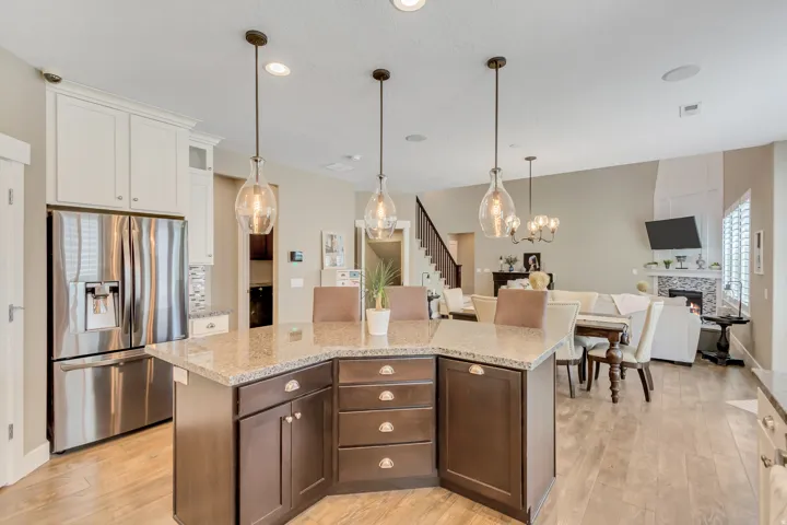 Kitchen island with a granite countertop and dark wood cabinetry