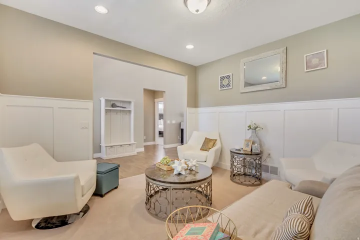 Living area featuring wainscoting and recessed lighting