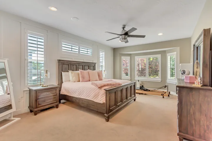 Spacious room featuring neutral carpeting and a ceiling fan with integrated lighting