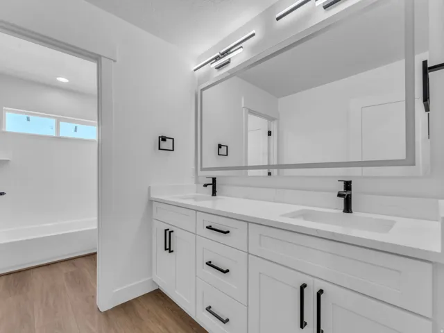 Dual vanity with integrated sinks and white countertops