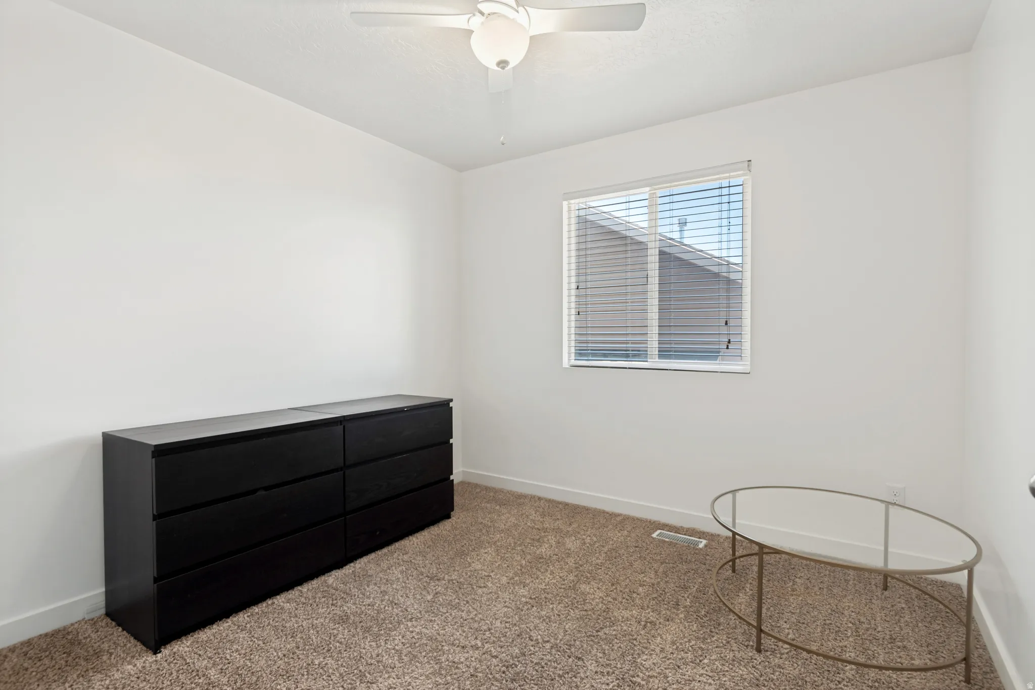 Room with white walls, a single window with blinds, and a ceiling fan