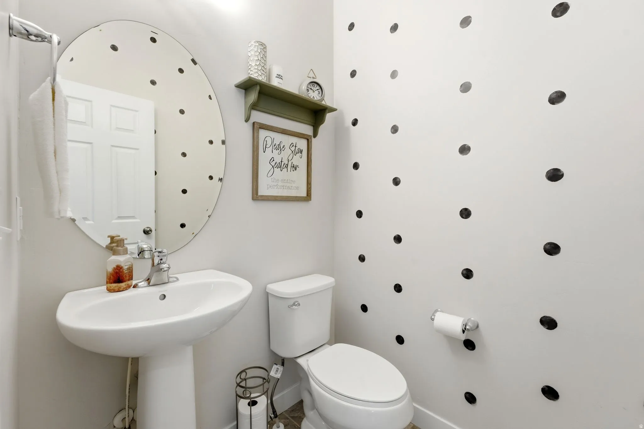 White pedestal sink with chrome faucet