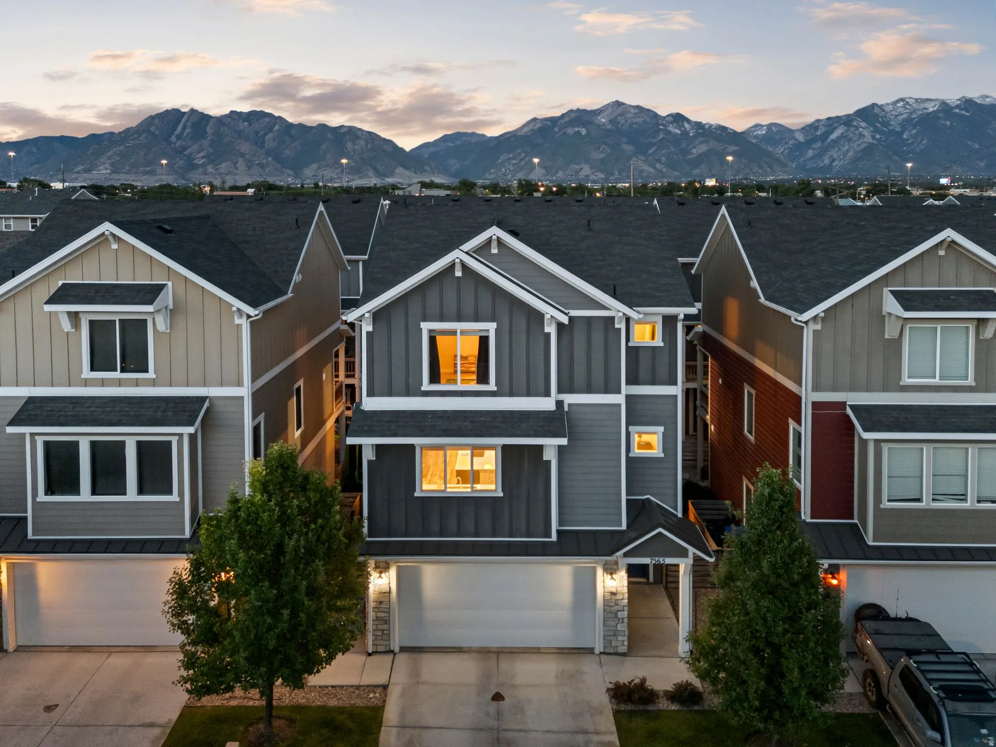 Contemporary townhome exterior featuring multi-toned siding, white trim, and a two-car garage