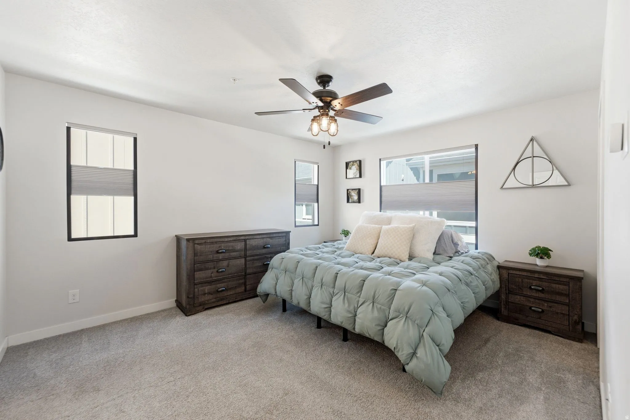 Carpeted room featuring light-toned walls and multiple windows with blinds
