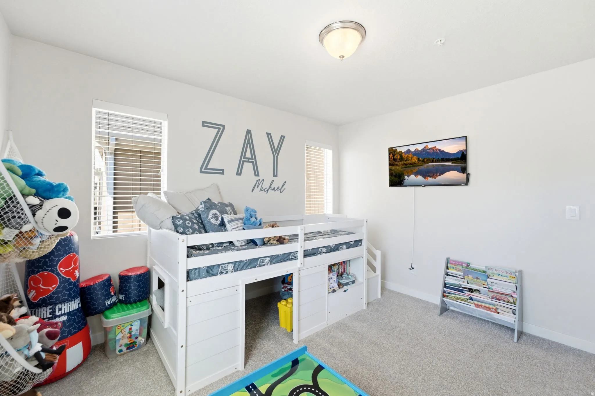 Bright room featuring neutral wall paint and light gray carpeting
