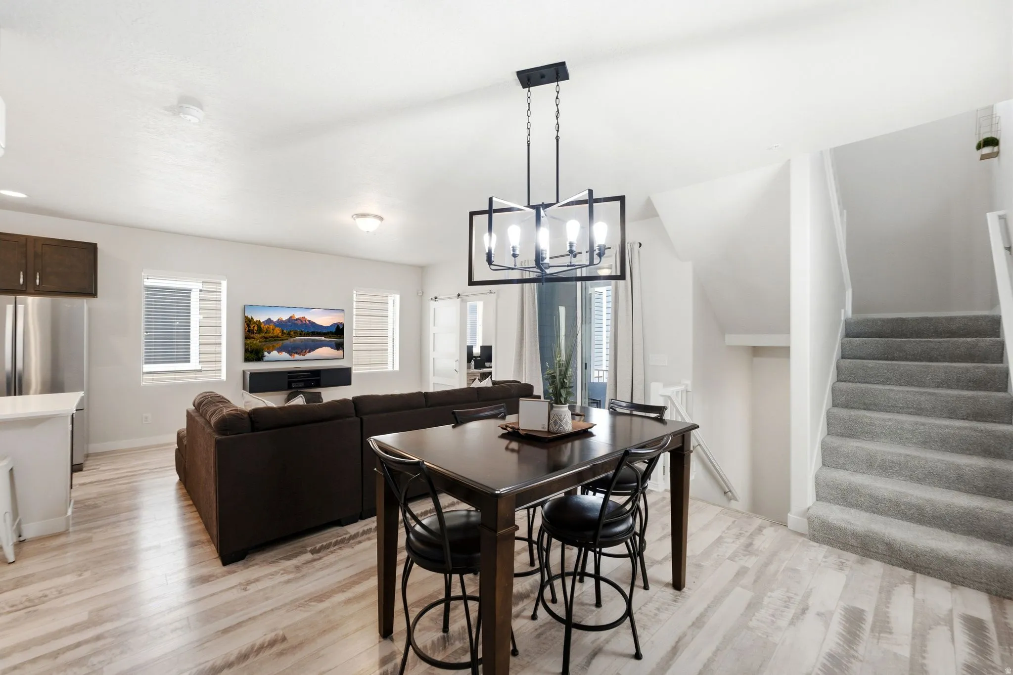Open-concept living area with light wood-finish flooring