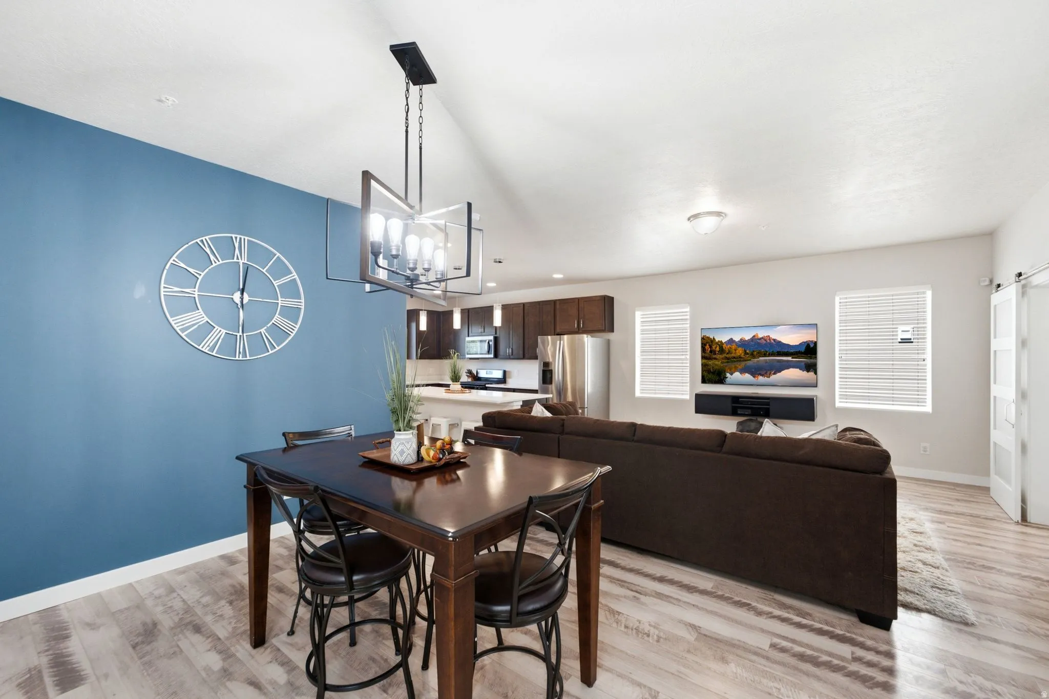 Open-concept living space with wood-finish flooring and vaulted ceilings