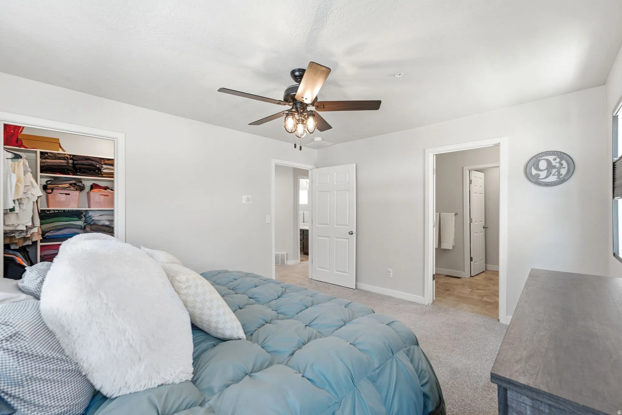 Neutral gray walls with white trim, featuring a ceiling fan with light fixture