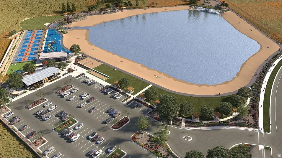 Expansive recreational complex featuring a large lake with sandy beach, multiple sports courts, a structured playground area, a community building, and an extensive parking area