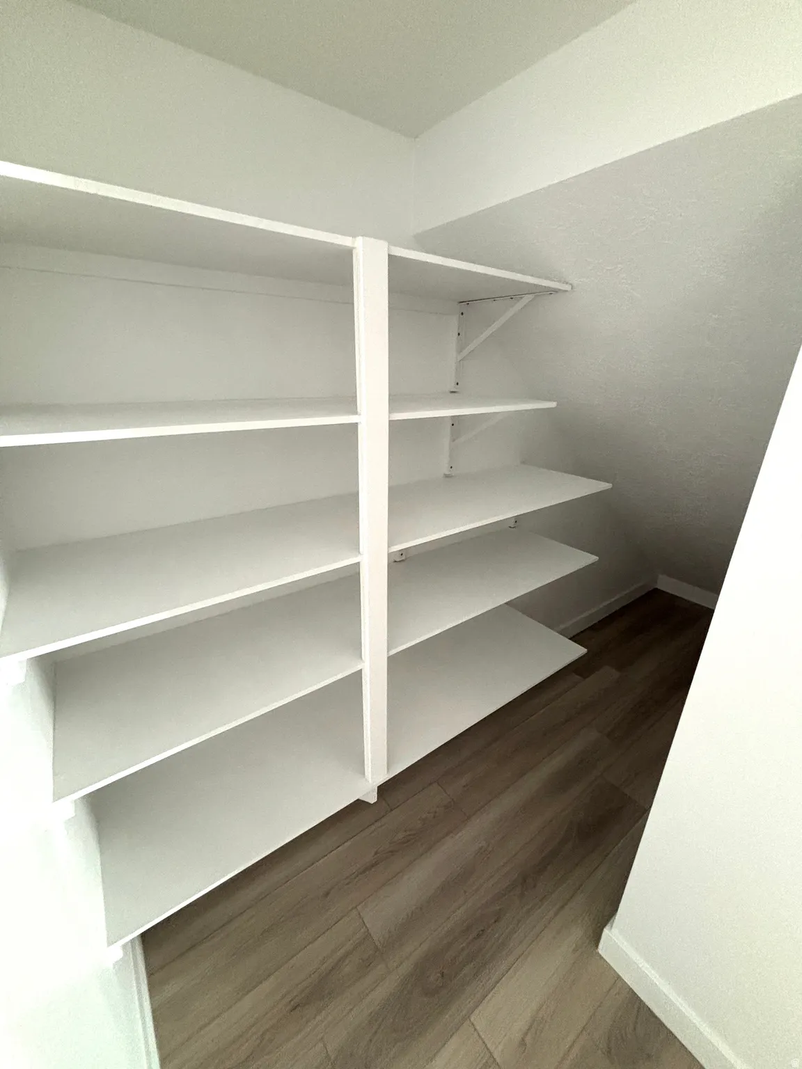 Built-in white shelving system with multiple adjustable shelves