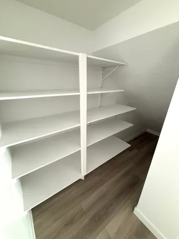 Built-in white shelving system with multiple adjustable shelves