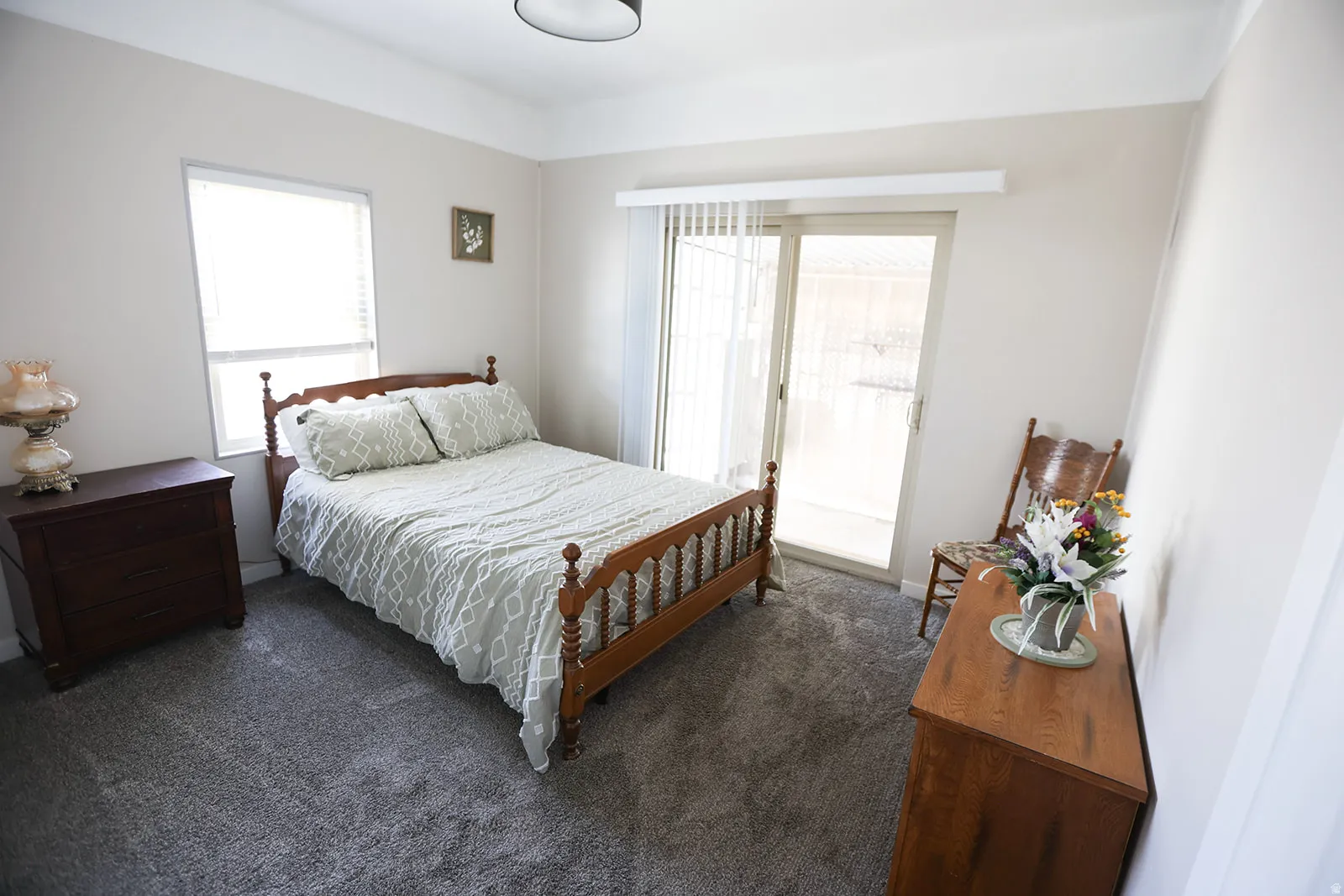 Bright interior space featuring light-colored walls and grey carpet flooring