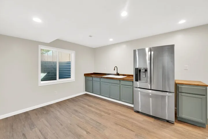 Wood-finish flooring complemented by light-toned walls and recessed ceiling lighting