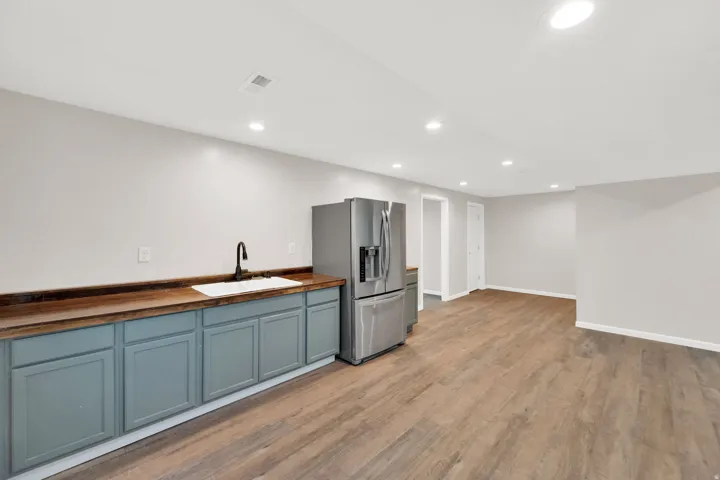 Spacious room with wood-finish flooring, recessed lighting, and light gray walls