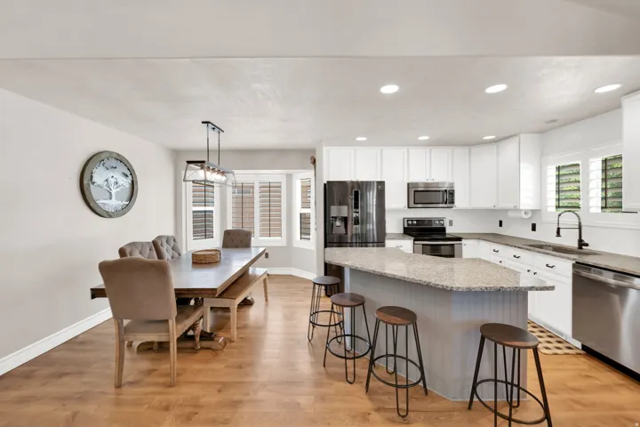 Expansive kitchen and dining area featuring light wood-finish flooring