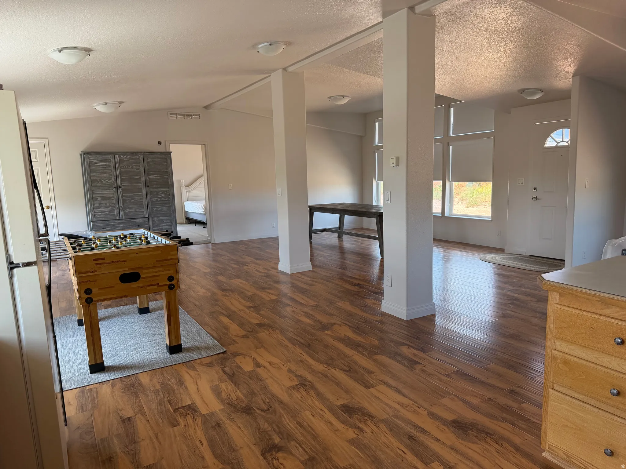 Expansive open-concept interior featuring wood-finish flooring throughout