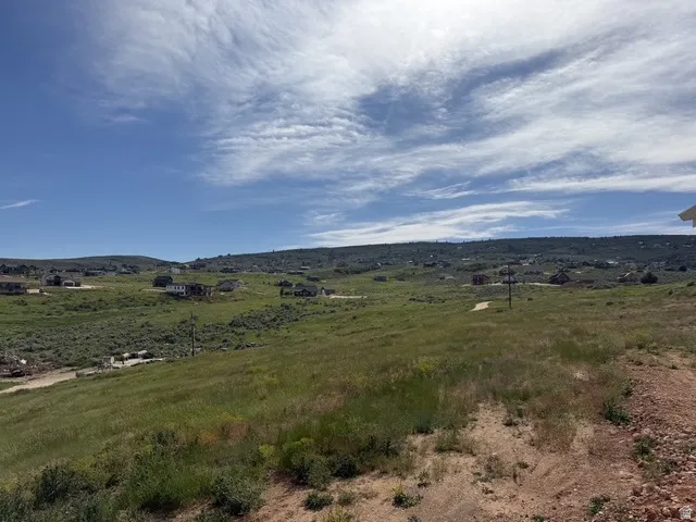 Expansive undeveloped land featuring rolling hills and distant properties