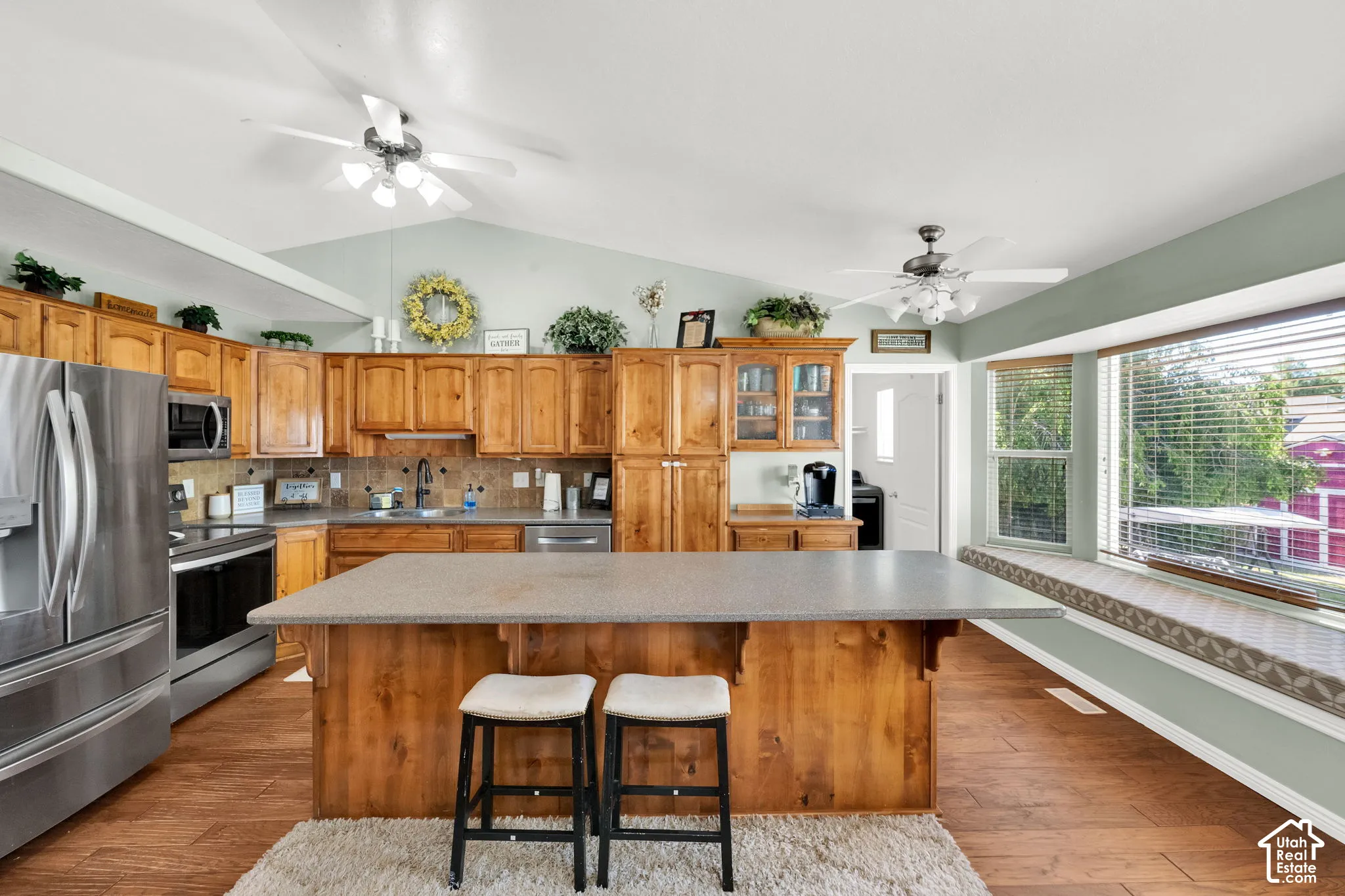 Kitchen featuring a central island, wood-finish flooring, and natural wood cabinetry