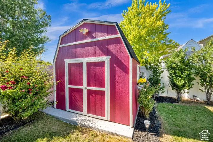 Red barn-style shed with white trim and double doors