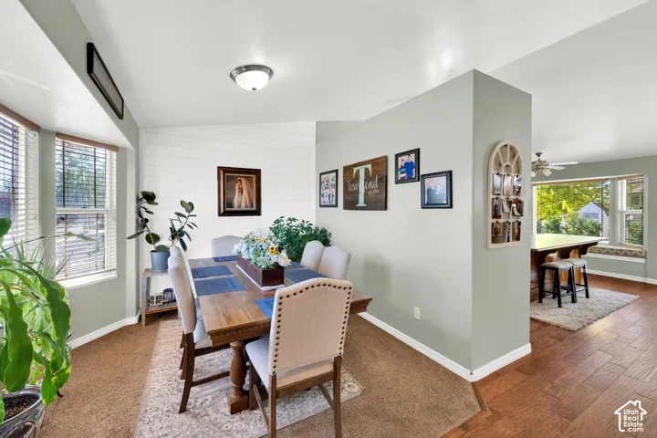 Dining area with bay windows and natural wood-finish flooring