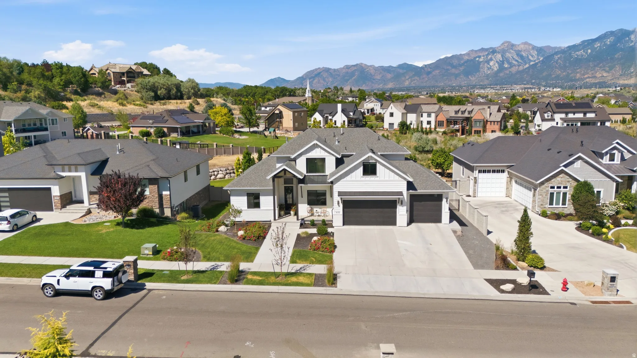 Contemporary residence featuring a light gray exterior with dark trim accents
