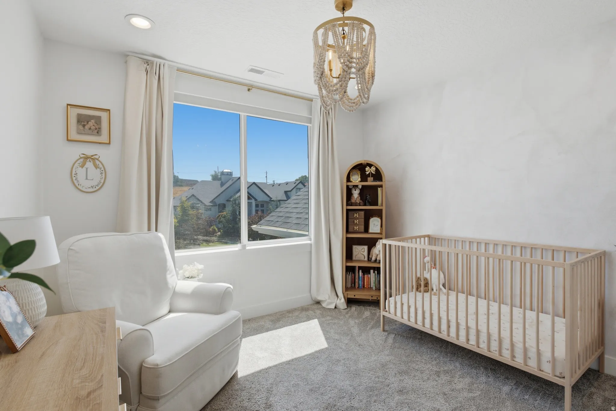 Bright room featuring a large window, recessed lighting, and a decorative overhead light fixture