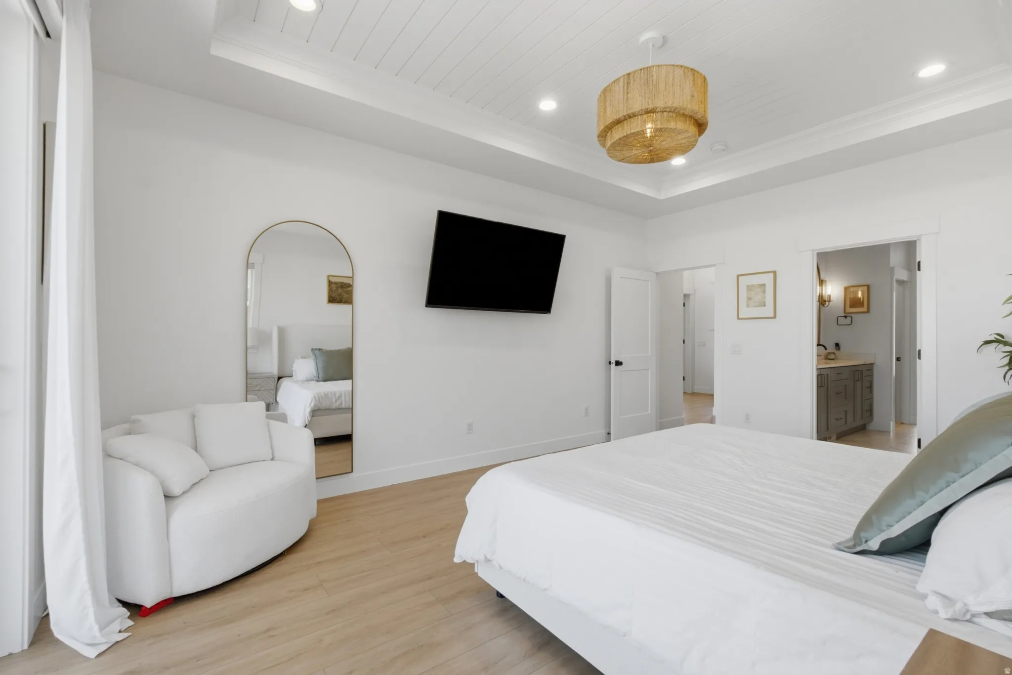 Spacious room with light wood-finish flooring, a tray ceiling featuring shiplap detailing, and recessed lighting