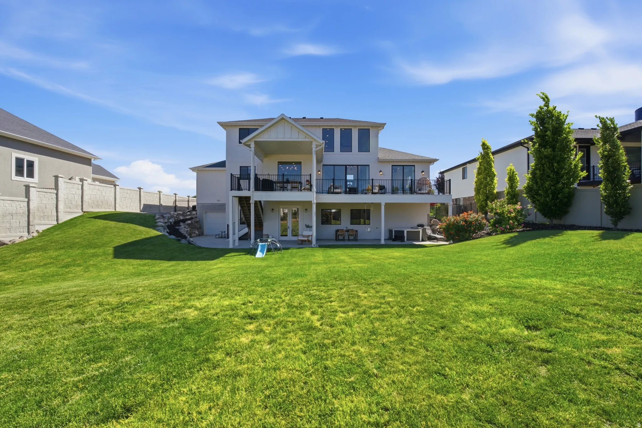 Spacious rear yard with expansive lawn and established landscaping
