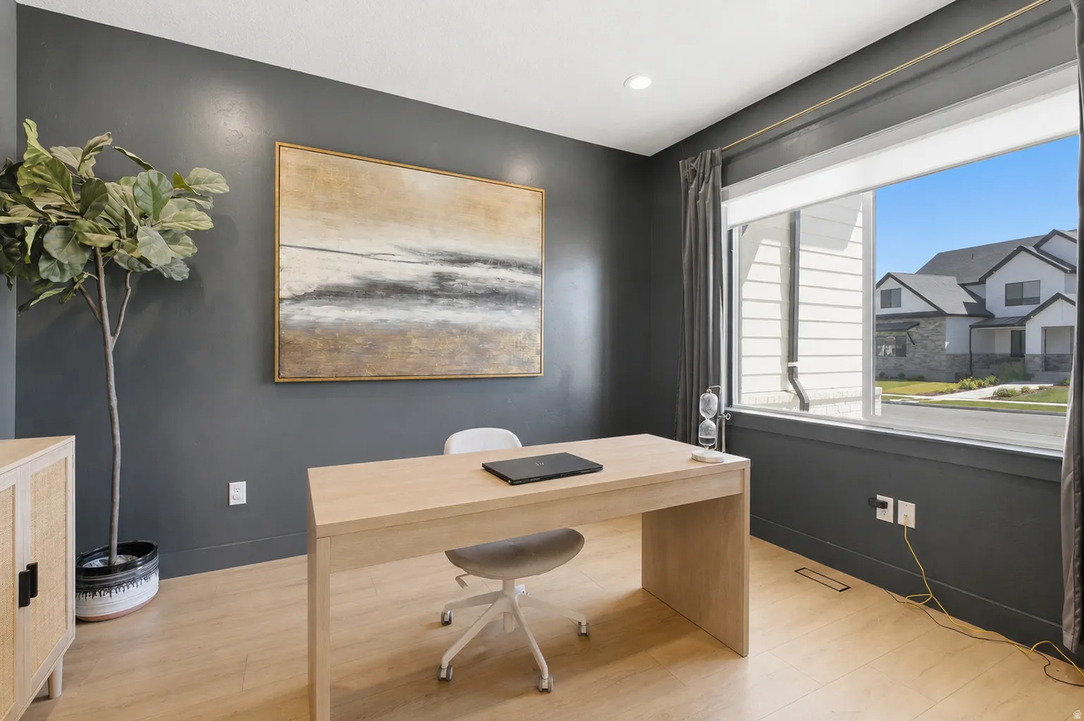 Dedicated room featuring light wood-finish flooring and dark accent walls