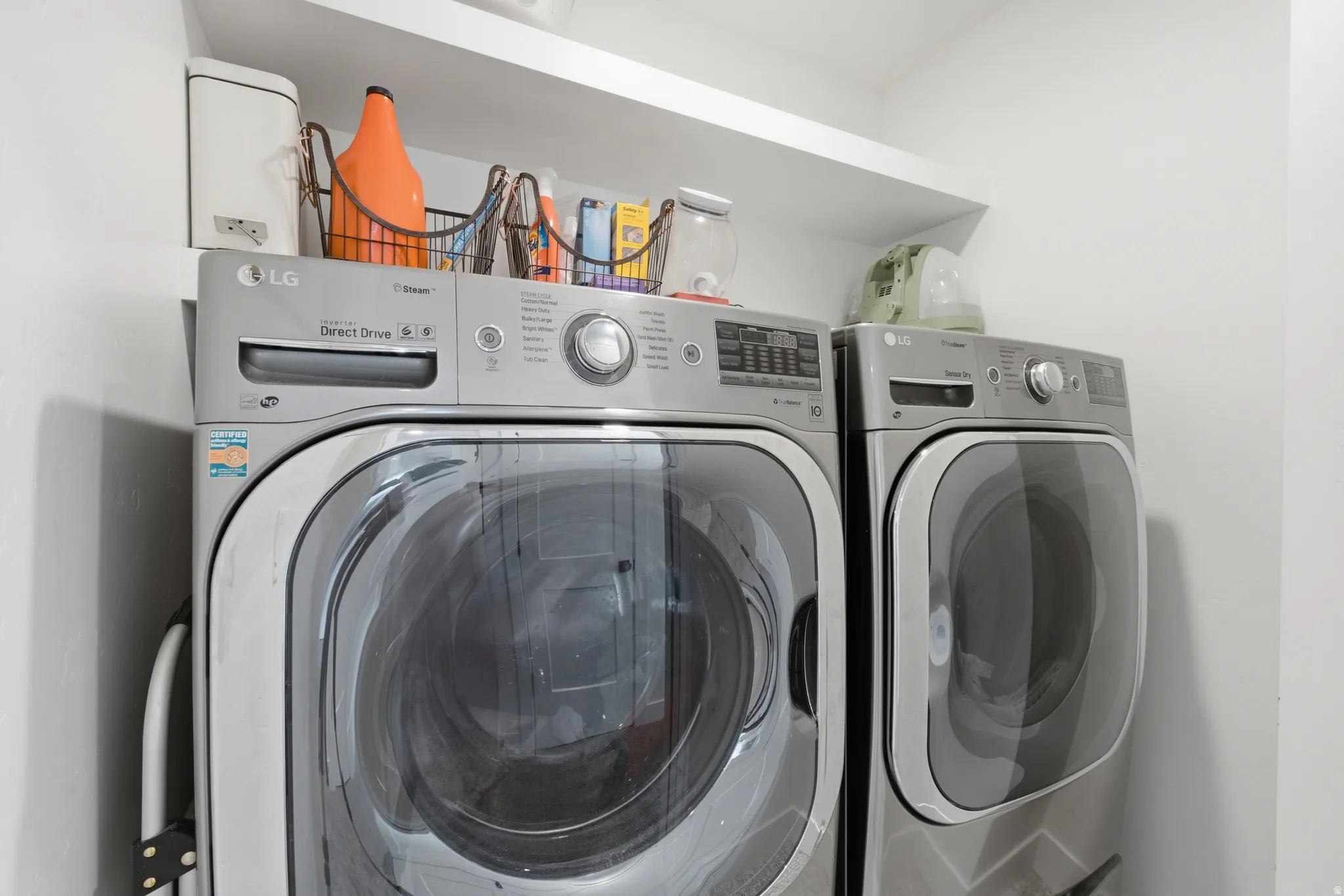 Dedicated laundry area featuring a front-loading washer and dryer set