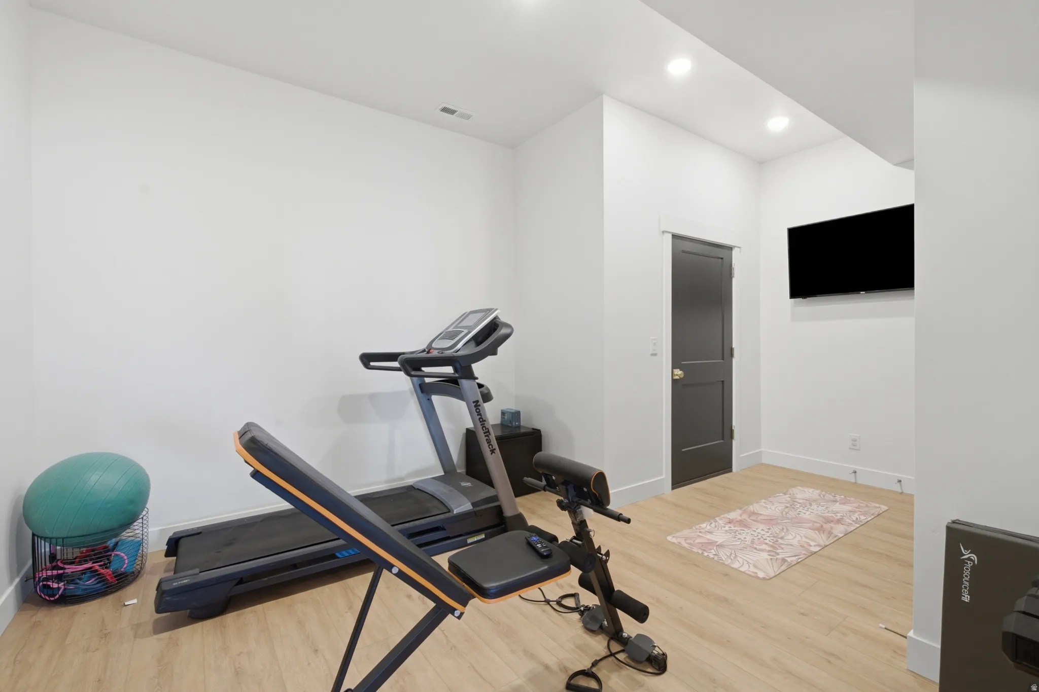 Bright interior space featuring light wood-finish flooring, recessed lighting, and white walls