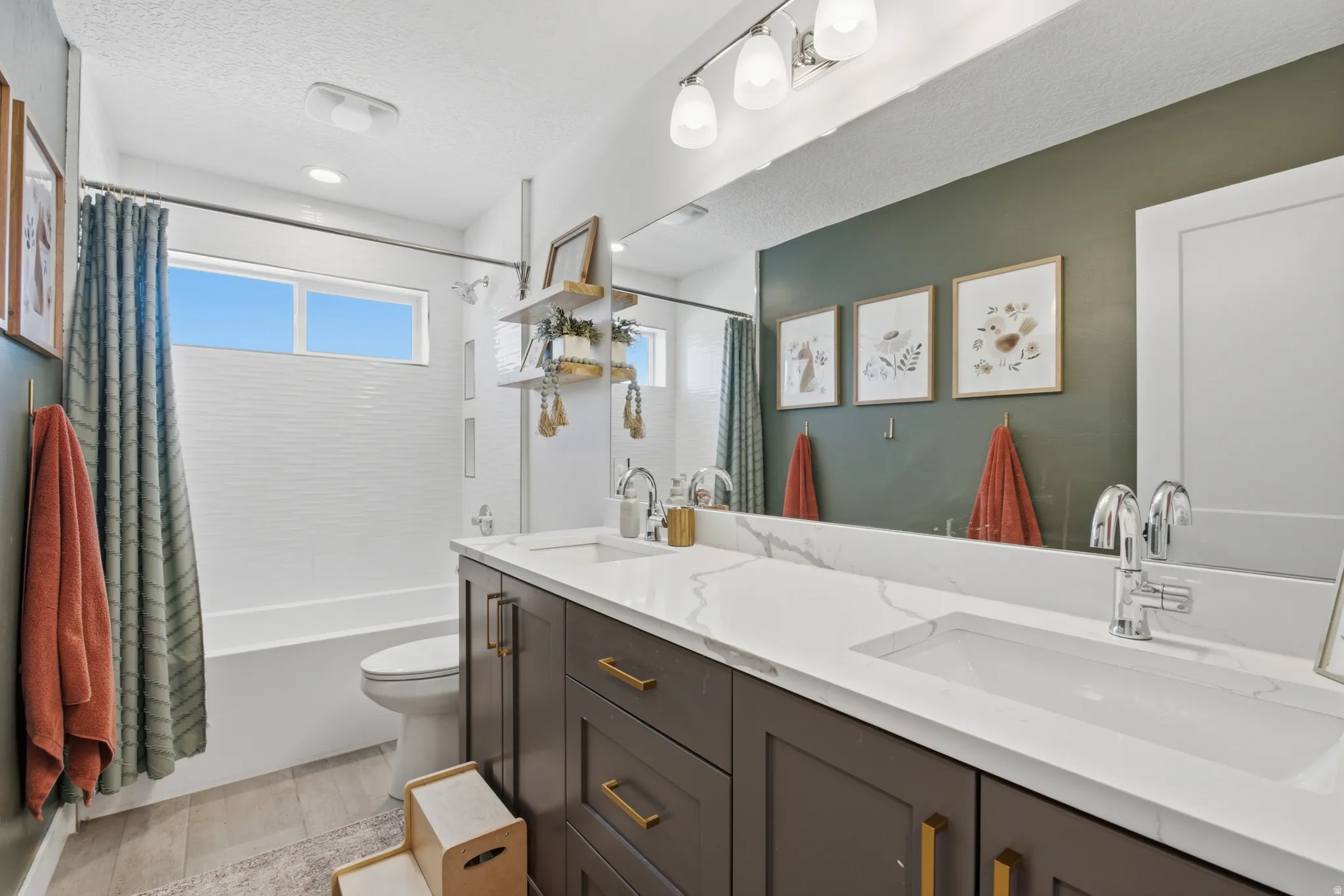 Double vanity featuring integrated sinks and white countertops