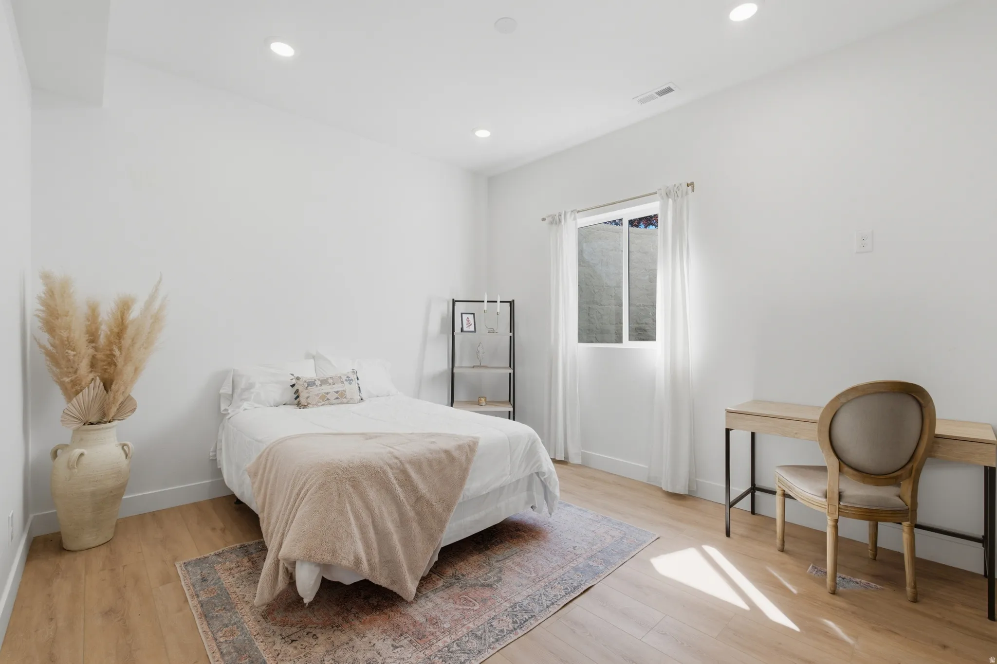 Bright interior space featuring wood-finish flooring and recessed lighting
