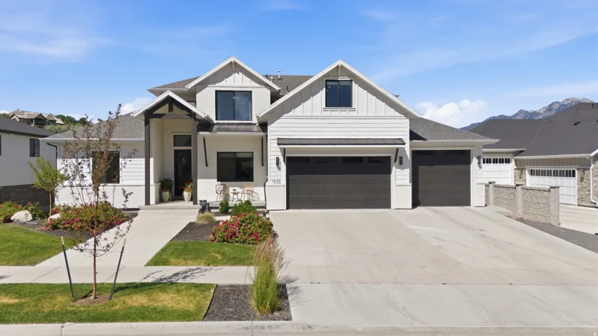 Modern farmhouse-style exterior with white siding and dark trim