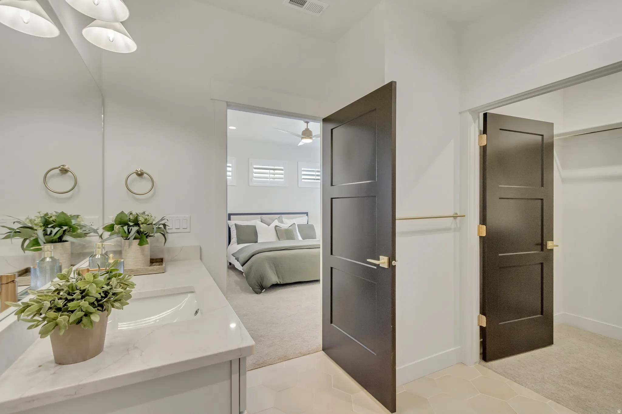 Bathroom vanity featuring a single undermount sink and a light-colored countertop