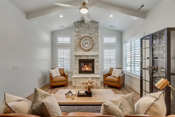 Vaulted ceiling featuring exposed beams and a modern ceiling fan
