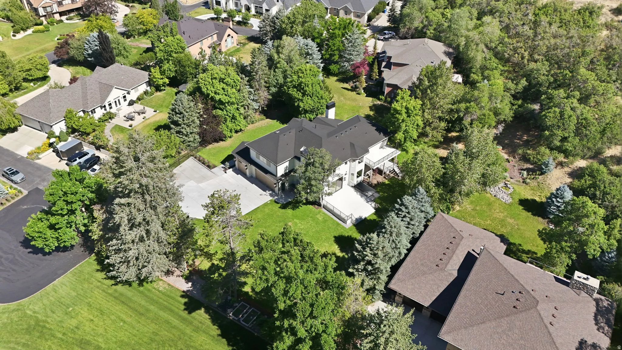No side neighbors, two-story residence with a dark shingle roof, white exterior, and multiple balconies