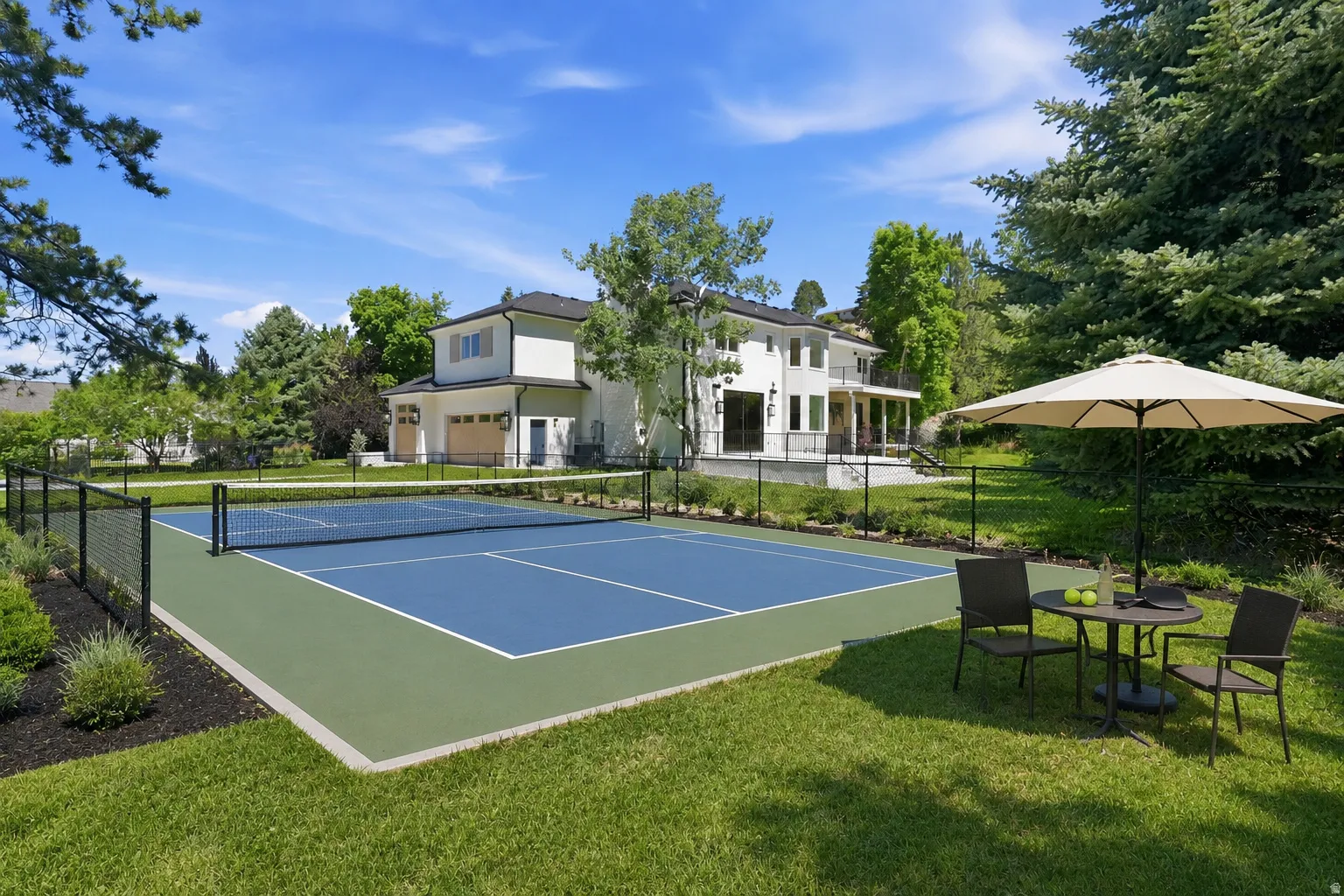 Virtually staged full-sized tennis/ pickleball  with blue and green surfacing. Also would have room for a pool!