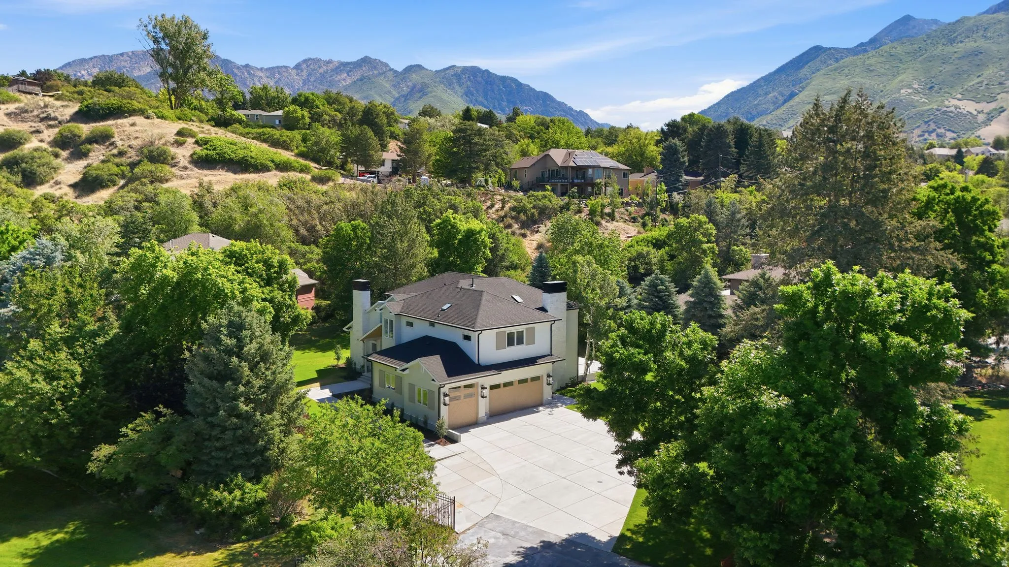 Contemporary two-story residence with a three-car garage and a large concrete driveway