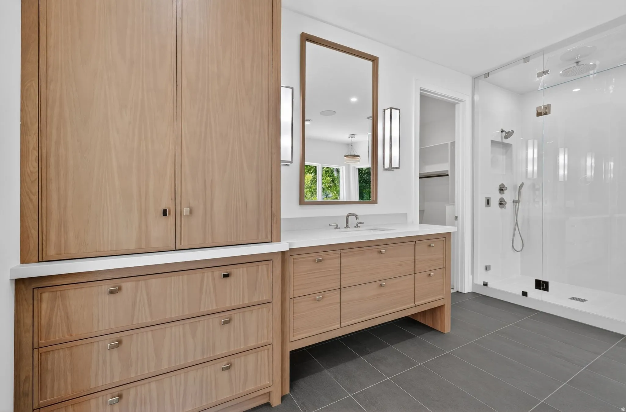 Light wood-finish cabinetry and drawers provide storage