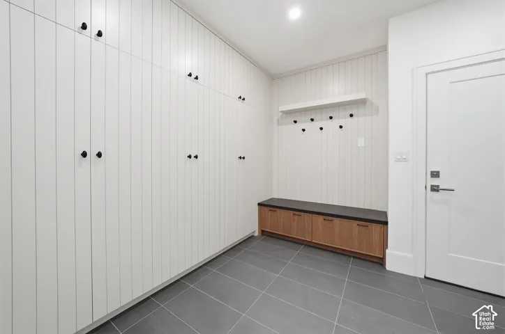 Integrated mud room storage wall with matte black hardware