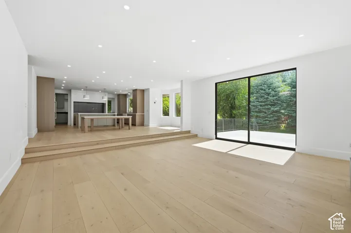 Spacious interior featuring light wood-finish flooring and a multi-level design