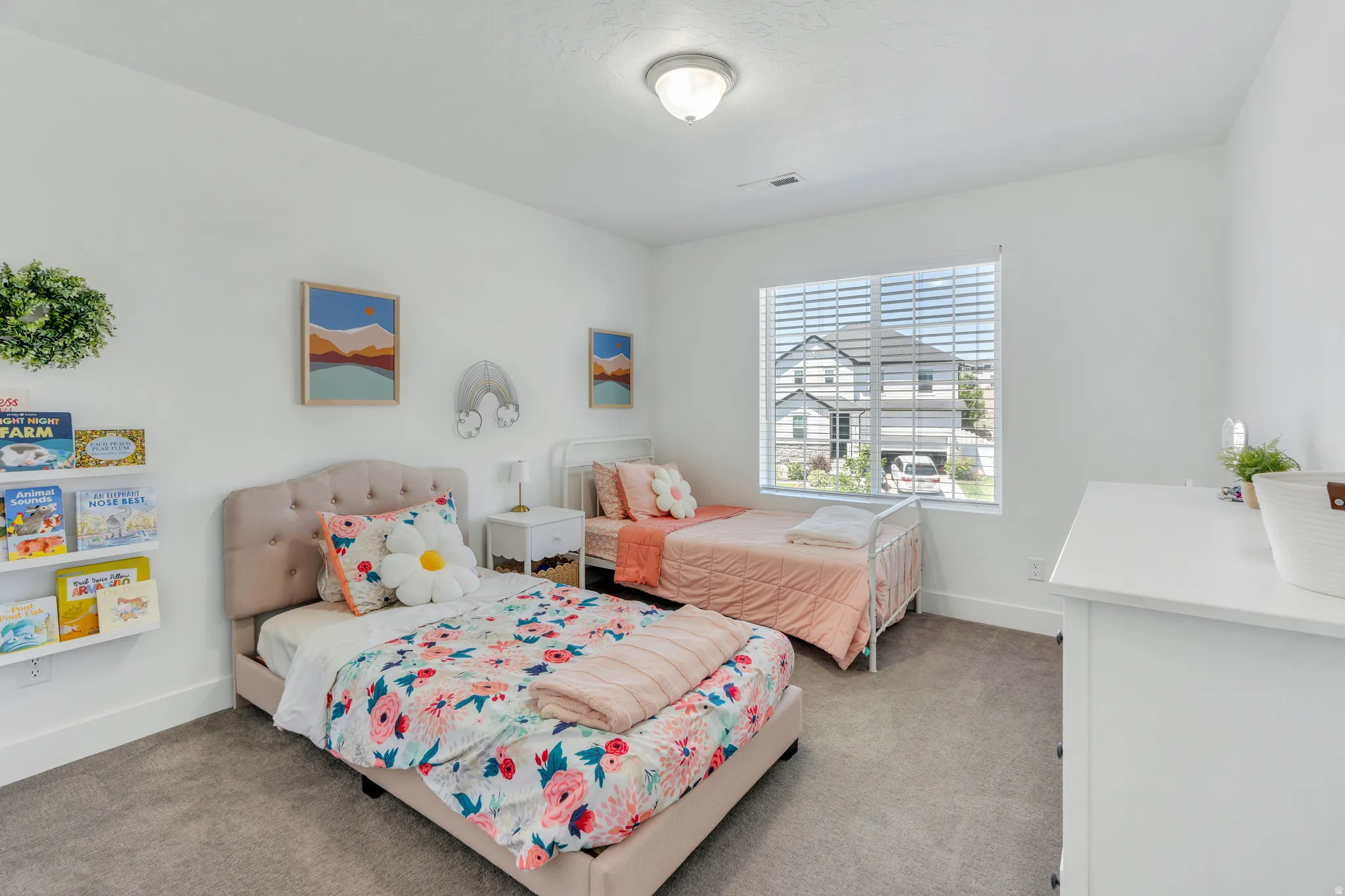 Bright interior space featuring white walls and gray carpet flooring