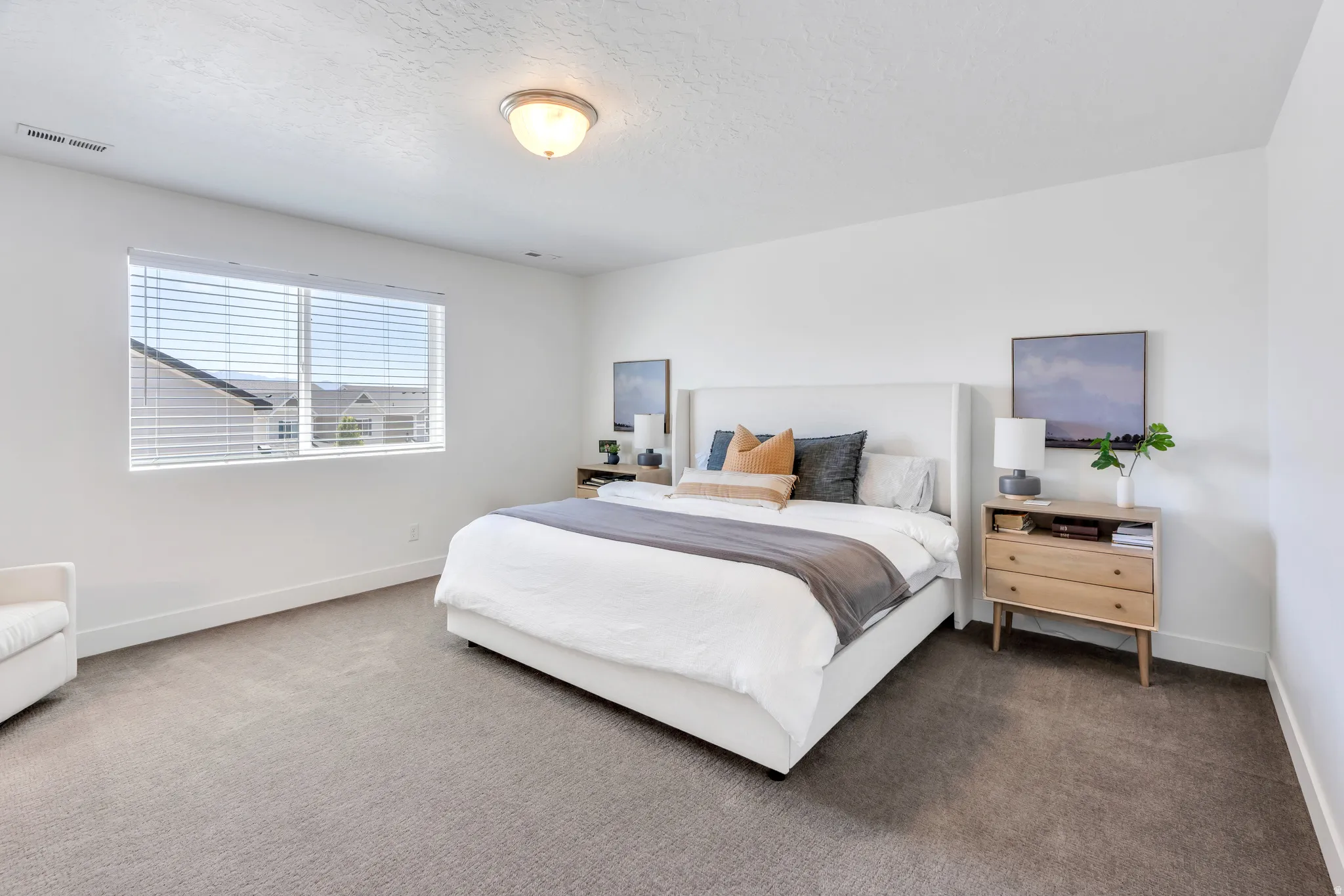 Spacious room featuring neutral carpeting and white walls